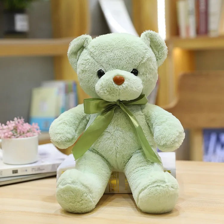 Ours en peluche vert clair, nĆud satinĂ©, doux, mignon, cĂąlin.