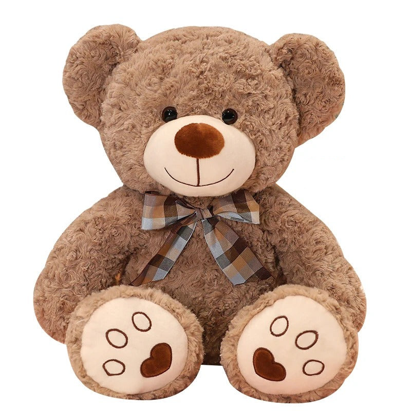 Adorable ours en peluche brun avec un nĆud papillon Ă carreaux, mesurant 35cm.