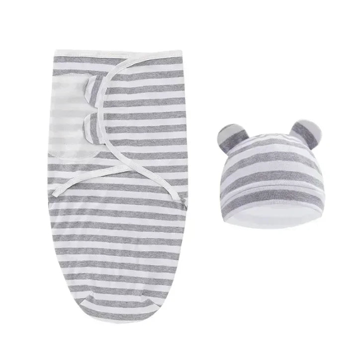 La Couverture emmaillotage bébé| Douce Câline™ est un lange rayé gris et blanc avec un bonnet à oreilles d'ours assorti, présenté sur fond blanc, idéal pour apaiser le réflexe de Moro et assurer un sommeil paisible.